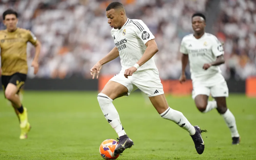 Kylian Mbappe dribbling for Real Madrid during a competitive football match