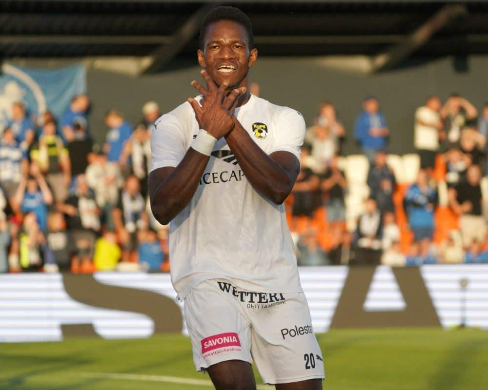 Mohamed Toure celebrating during a football match while playing in a white club kit