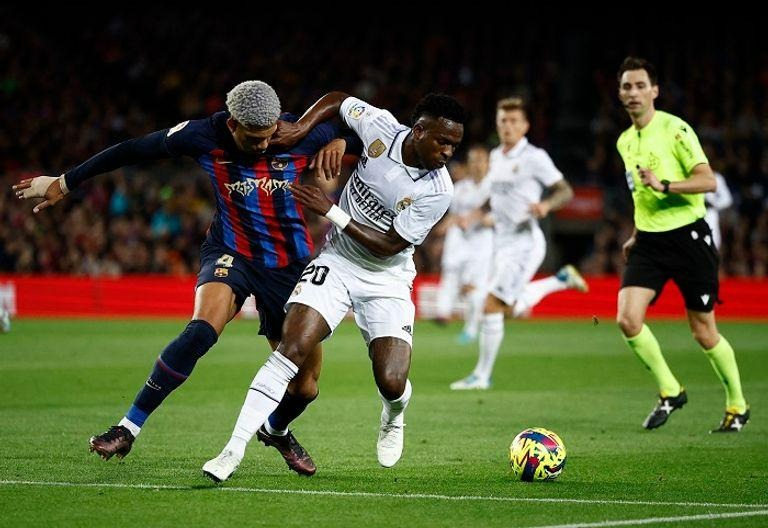 Vinicius Junior battling for possession for Real Madrid against Barcelona's Ronald Araujo during El Clasico